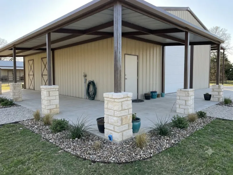 Metal building with decorative stone wrapped support columns and landscaped gravel base